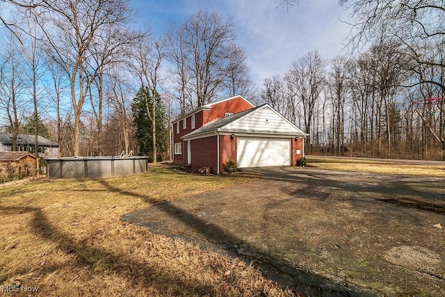 exterior space featuring an outdoor pool and driveway