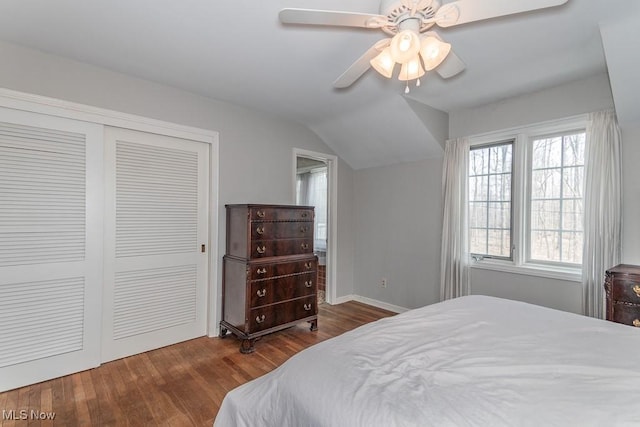 bedroom featuring a ceiling fan, lofted ceiling, wood finished floors, and a closet