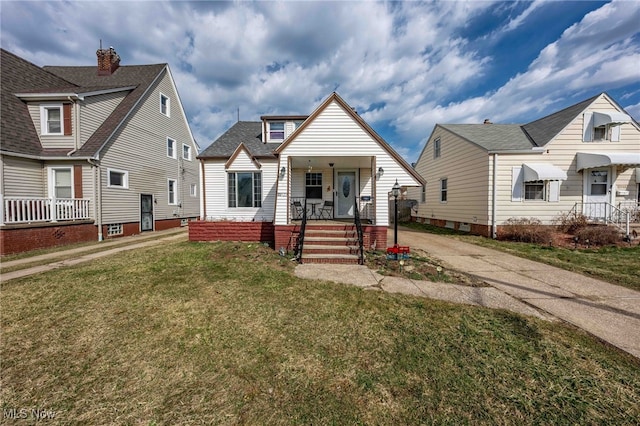 bungalow-style home with covered porch and a front yard