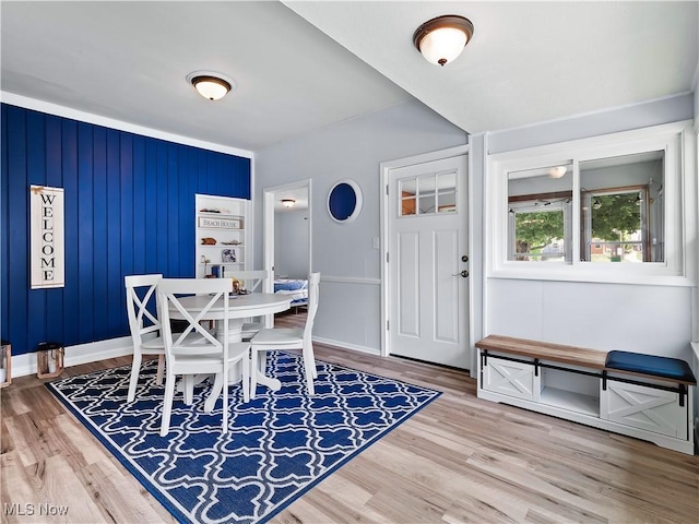 dining area with baseboards and wood finished floors