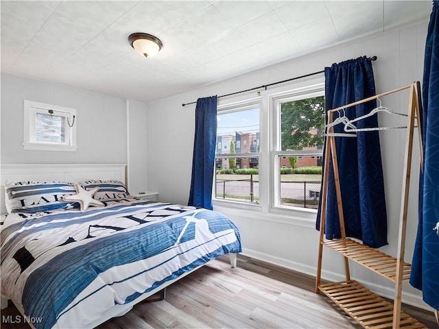 bedroom featuring wood finished floors and baseboards