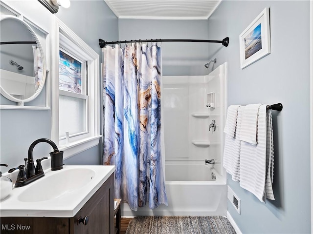 bathroom featuring shower / bath combo with shower curtain and vanity