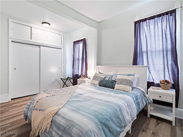 bedroom with a closet and wood finished floors