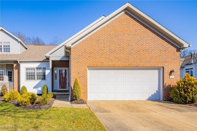 view of front facade featuring a garage, brick siding, and concrete driveway