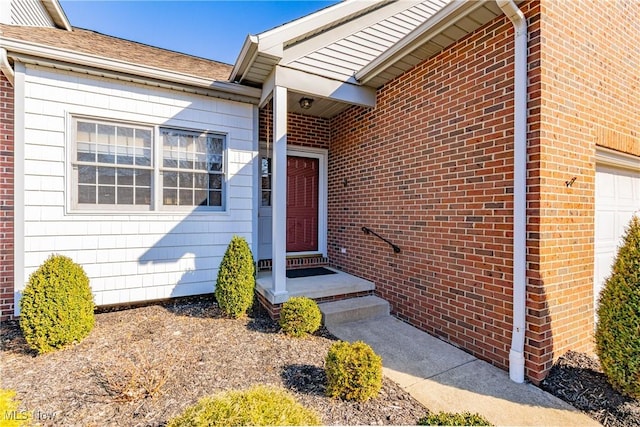 doorway to property with brick siding