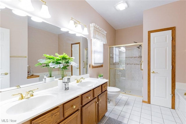 bathroom with a sink, double vanity, a shower stall, and tile patterned floors