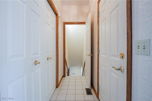 corridor featuring wallpapered walls, light tile patterned flooring, and visible vents