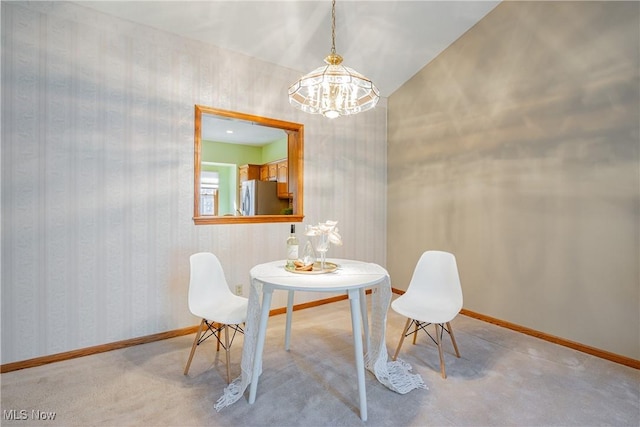 dining area with baseboards, a notable chandelier, carpet floors, and wallpapered walls