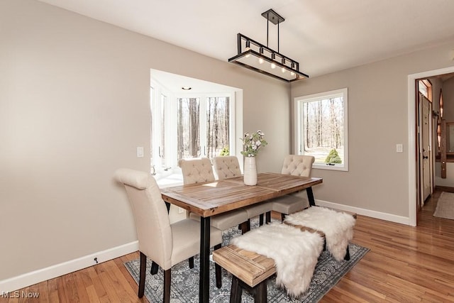 dining room with baseboards and light wood-style floors