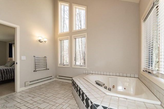 bathroom with ensuite bath, a tub with jets, and a baseboard radiator