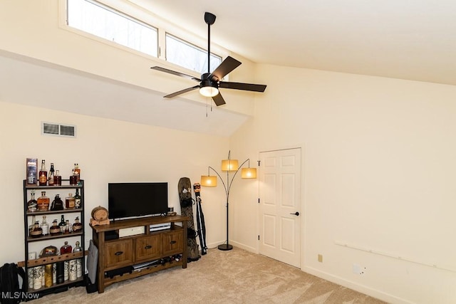 living area with visible vents, light carpet, high vaulted ceiling, a ceiling fan, and baseboards