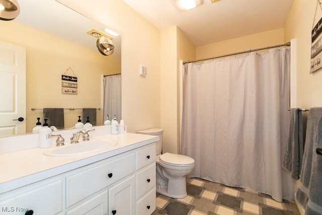 bathroom featuring tile patterned floors, toilet, and vanity