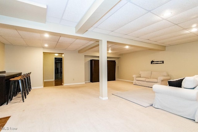 living area featuring recessed lighting, a paneled ceiling, baseboards, and light carpet