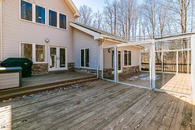 wooden deck featuring a grill and french doors