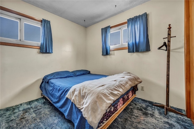 bedroom with a textured ceiling and carpet floors