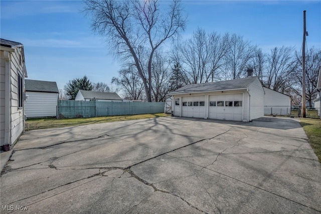 detached garage featuring fence