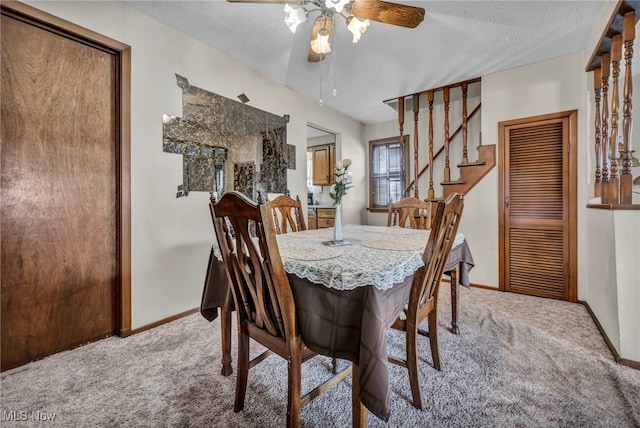 dining area with baseboards, stairs, carpet flooring, a textured ceiling, and a ceiling fan