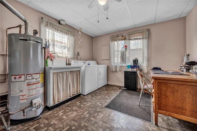 laundry area with baseboards, ceiling fan, gas water heater, laundry area, and independent washer and dryer