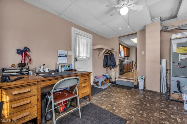 office area featuring a drop ceiling and ceiling fan