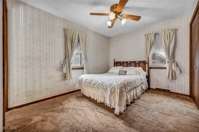 bedroom featuring wallpapered walls and baseboards