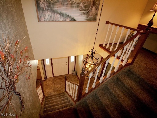 stairway with a high ceiling and carpet