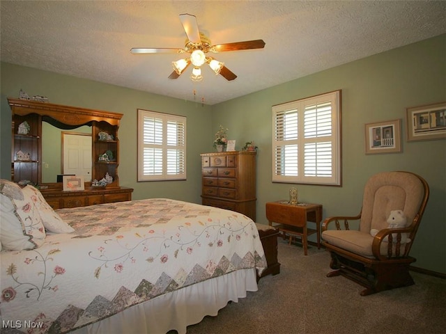 bedroom featuring carpet flooring, a textured ceiling, and ceiling fan