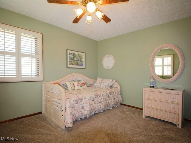 bedroom with baseboards, ceiling fan, a textured ceiling, and carpet