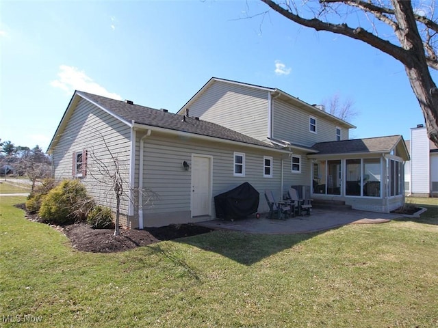 back of property featuring a lawn, roof with shingles, a patio, and a sunroom