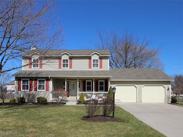 traditional home featuring a front lawn, a porch, concrete driveway, an attached garage, and a chimney