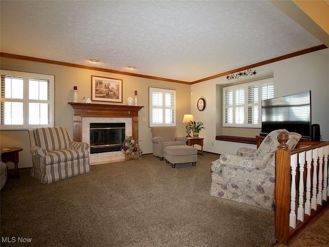 carpeted living room featuring a tile fireplace, a textured ceiling, and crown molding