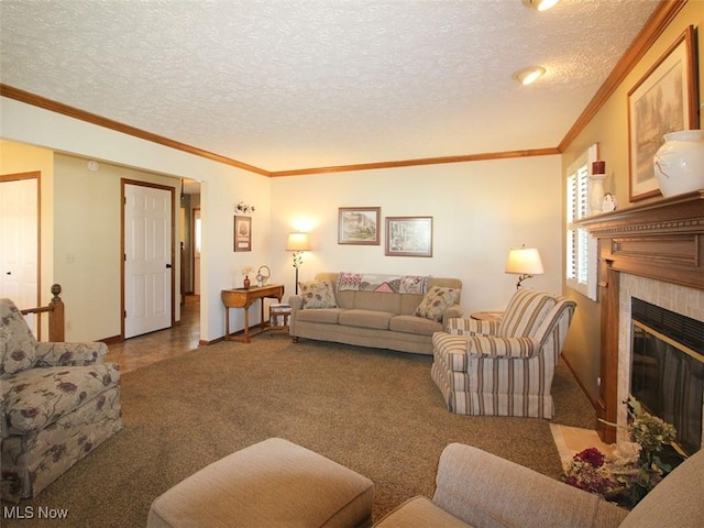 carpeted living room featuring a textured ceiling, crown molding, and a tile fireplace