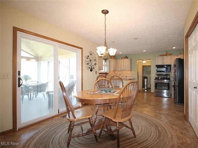 dining room with a notable chandelier, recessed lighting, baseboards, and a textured ceiling