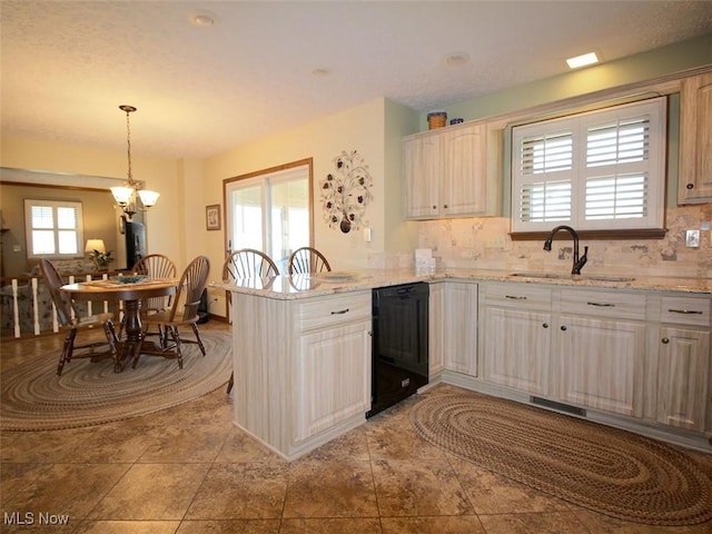 kitchen with a peninsula, a sink, hanging light fixtures, decorative backsplash, and dishwasher