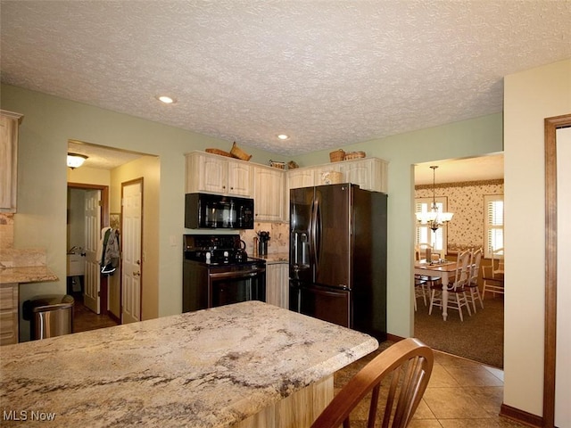 kitchen featuring black appliances, a notable chandelier, light tile patterned floors, and a textured ceiling