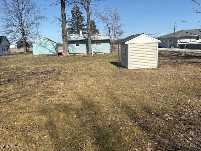 view of yard with an outbuilding and a storage shed