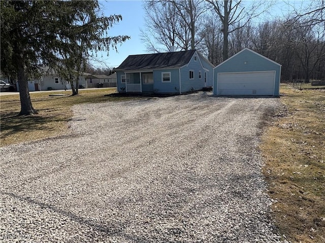 view of front facade with an outbuilding and a detached garage