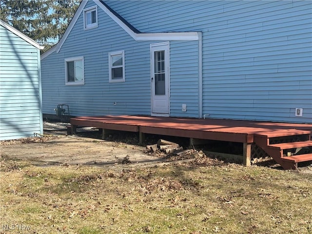 rear view of property featuring a wooden deck