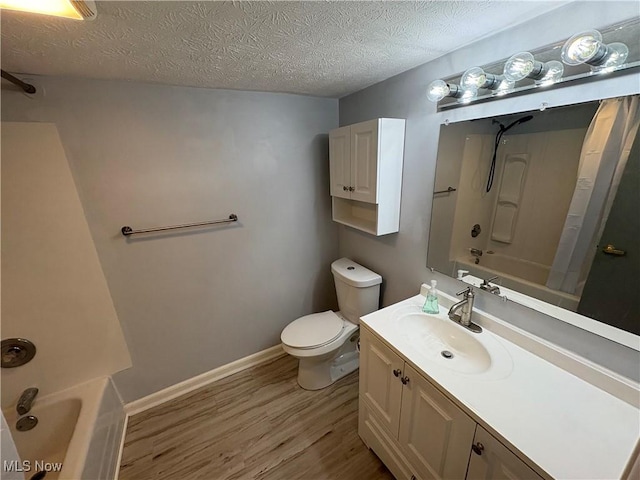 bathroom with baseboards, toilet, shower / bath combo with shower curtain, wood finished floors, and a textured ceiling