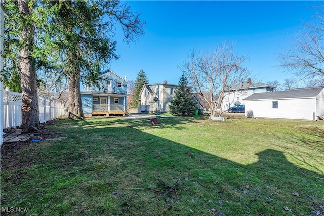 view of yard featuring a deck and fence