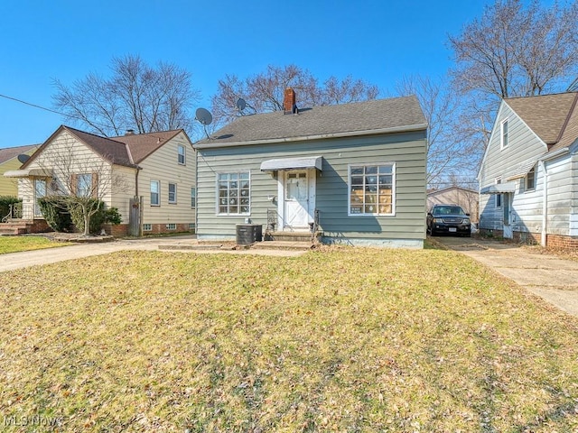 bungalow featuring a front lawn, central AC unit, driveway, and a chimney