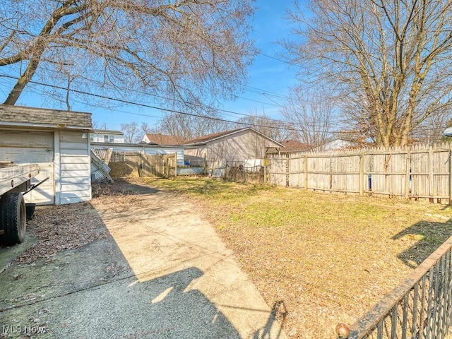 view of yard with an outdoor structure and fence