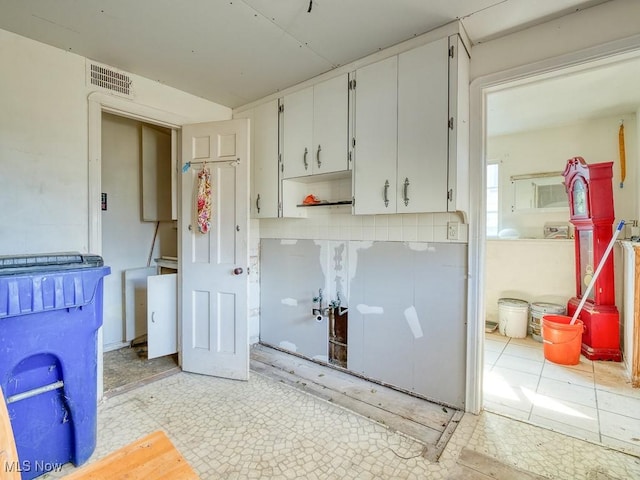 washroom featuring visible vents and light floors