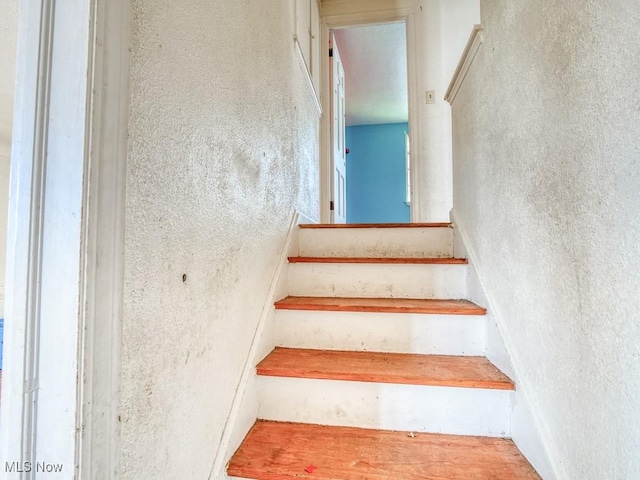 staircase with a textured wall