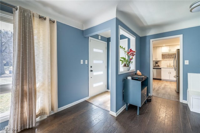 entrance foyer with baseboards and hardwood / wood-style floors