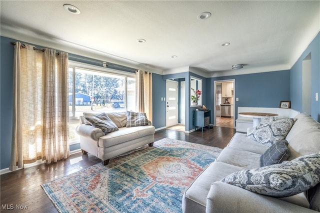 living area featuring recessed lighting, baseboards, and wood finished floors