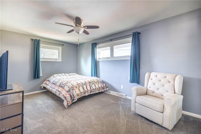 bedroom featuring baseboards, carpet floors, visible vents, and a ceiling fan