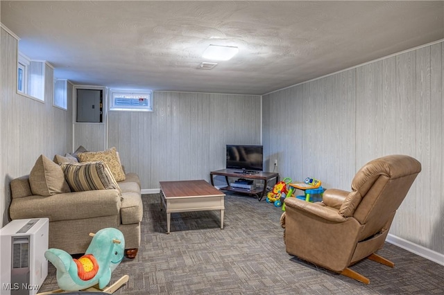 living area with electric panel, baseboards, and carpet floors