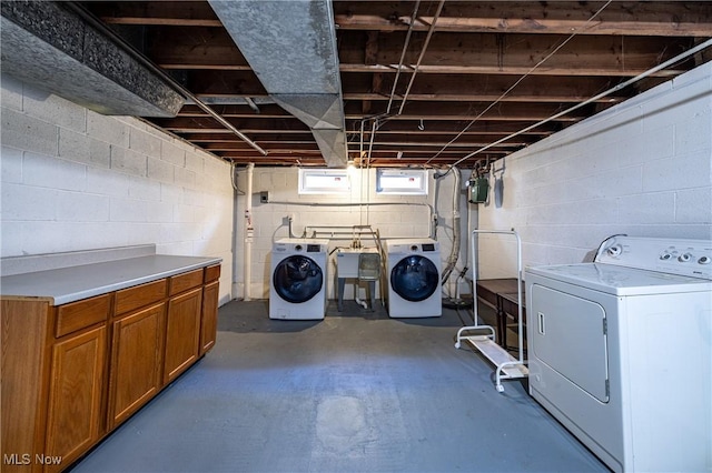 washroom with cabinet space and washing machine and clothes dryer