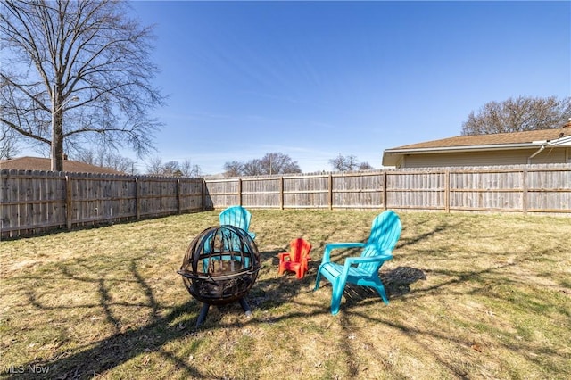 view of yard with an outdoor fire pit and a fenced backyard