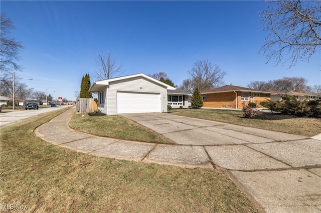 view of home's exterior with a yard, concrete driveway, a garage, and fence